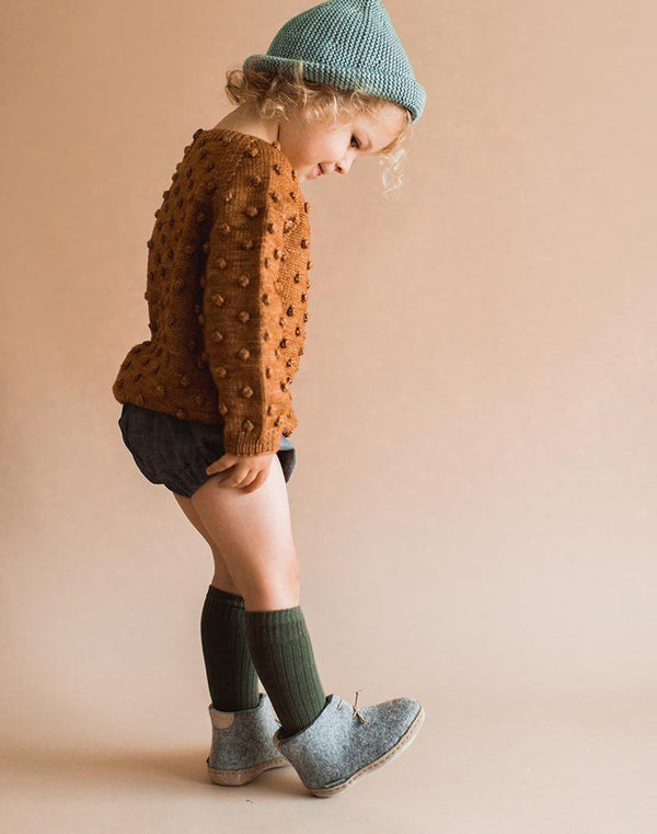 Baby wearing knee socks and grey Glerups Wool Baby Boots
